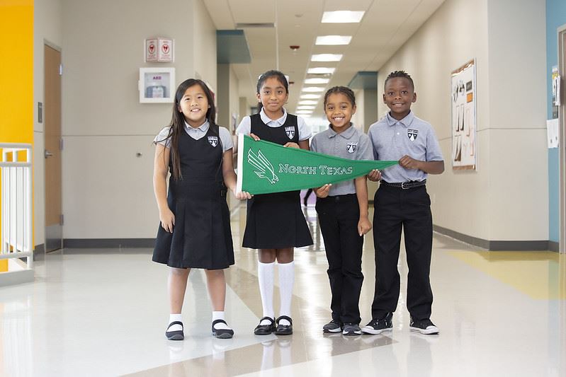 Primary scholars showcasing UNT flag. Primary scholars showcasing UNT flag.