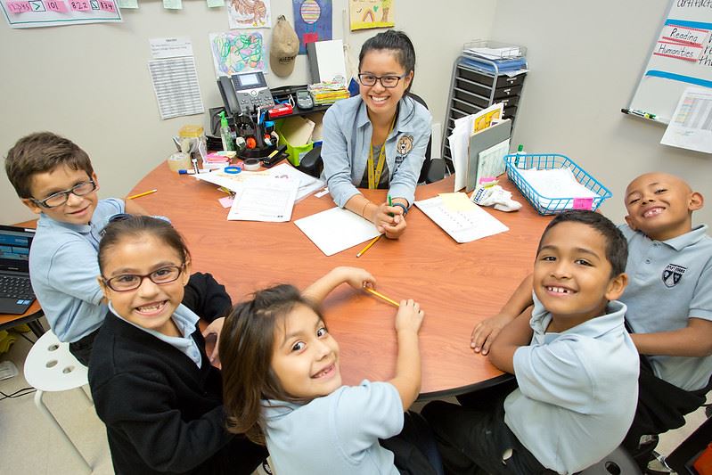 Smiling scholars and their teacher Smiling scholars and their teacher